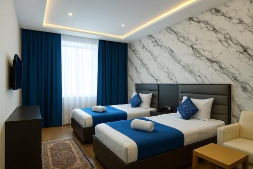 Llit o llits en una habitació de Vatan Hotel