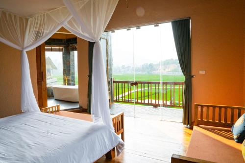 a bedroom with a bed with a view of a balcony at Diều Sóc Sơn in Sóc Sơn