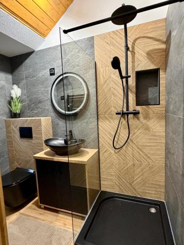 a bathroom with a sink and a mirror at Csuszka Vendégház MÁTRA in Mátraszentimre