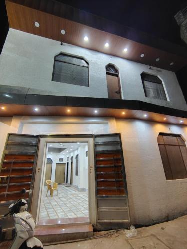 a man sitting on a bench in front of a building at Param Dham in Vrindāvan