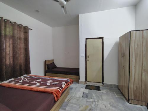 a room with a bed and a couch in it at Param Dham in Vrindāvan