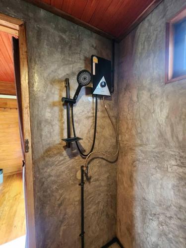 a corner of a room with a fan on the wall at Chill House Mae Sariang in Ban Mae Salap