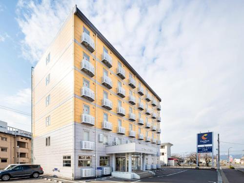 a tall building with balconies on the side of it at Comfort Inn Yokaichi in Higashiomi