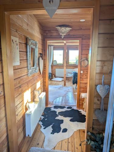 a room with wooden walls and a hallway with a rug at Holzhaus in Langatte