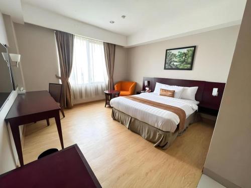 Ένα ή περισσότερα κρεβάτια σε δωμάτιο στο Asialink Premier