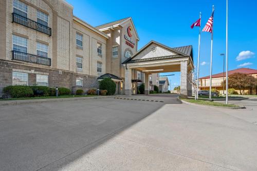 a hotel building with a parking lot in front of it at Comfort Suites Conway in Conway