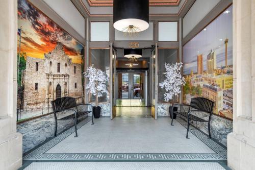 a lobby with two chairs and a painting on the wall at Hotel 1914 - Historic Alamo Riverwalk, an Ascend Collection Hotel in San Antonio