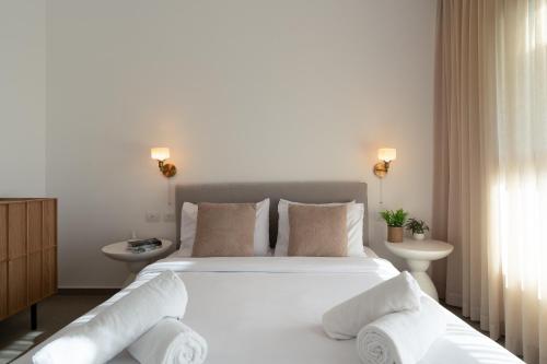 a bedroom with a large white bed with pillows at DreamyRent Aqua Sol Eilat in Eilat