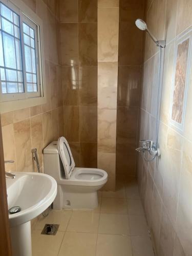 a bathroom with a toilet and a sink and a shower at Big studio apartment in Makkah