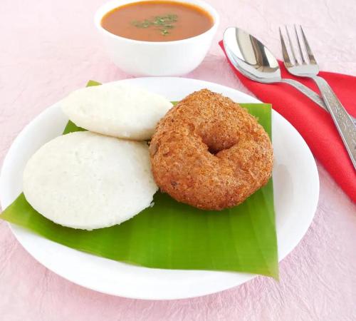 a plate of food with a donut and a bowl of soup at The Serene Shores - Luxury Private Villa in Puducherry