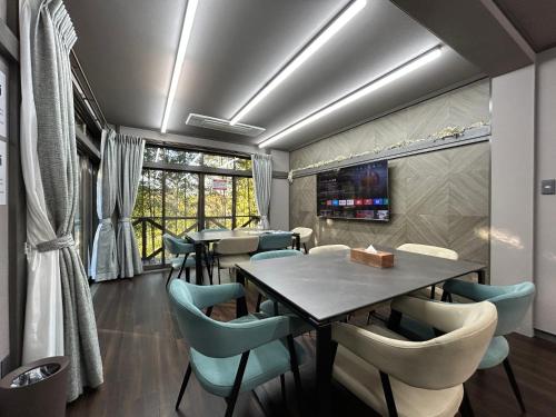 Ogiファミーユ 一碧湖 湖近く 温泉 屋根付バーベキューテラス 1棟貸切宿的餐厅里有一张桌子和几把椅子