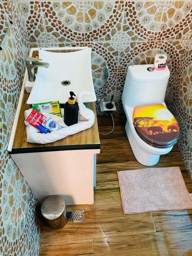 a bathroom with a toilet and a sink at Couple room A in Final Destination Resort in Bolinao