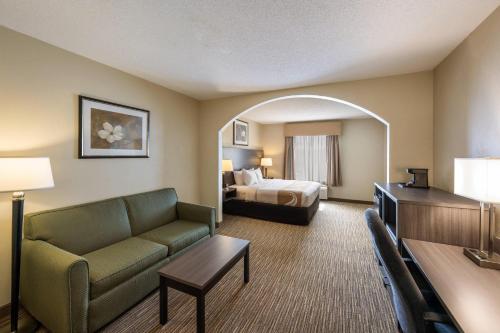 a hotel room with a couch and a bed at Quality Inn & Suites Fishkill South near I-84 in Fishkill