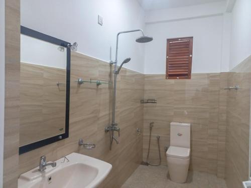 a bathroom with a shower and a sink and a toilet at Relax inn modara in Mirissa