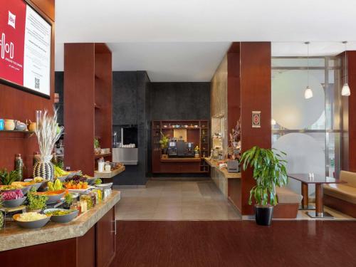 a kitchen with bowls of fruit on a counter at ibis Kuwait Salmiya in Kuwait