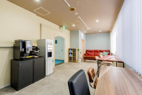 a living room with a table and a couch at Sea Side Gaia Resort HOTEL シーサイドガイアリゾートホテル in Sendai