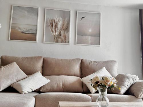 a living room with a couch and pictures on the wall at Albaicin Rolando FreshApartment in Granada