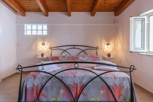 a bedroom with a bed with a metal frame at Al Quindici in Gaeta