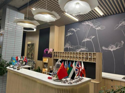 a lobby with a counter with flags on it at Luxury City Apartments in Baku