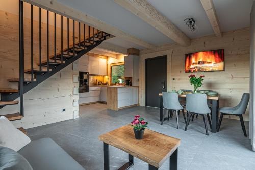 a kitchen and living room with a staircase in a house at Zielone Wzgórze Sidzina in Sidzina