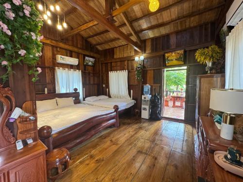 a bedroom with a bed in a wooden room at Cat Tien Vista in Tân Phú