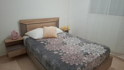 a bedroom with a bed with a wooden headboard and pillows at Le cocon drargua in Agadir