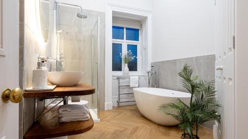 a bathroom with a large tub and a sink at Plas Madoc Lodge in Conwy