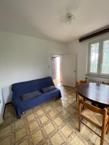 a living room with a blue couch and a table at Villa Adele Città Sant'Angelo in Citta' Sant'Angelo