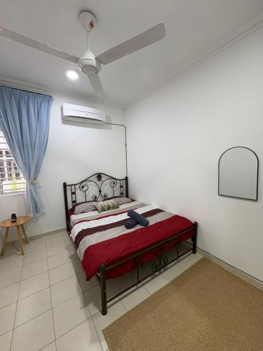 a bedroom with a bed and a ceiling fan at AzHomes AG in Kampong Jelatang