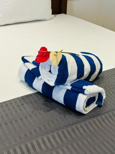a blue and white towel on a bed at Costal View-Ahangama in Ahangama