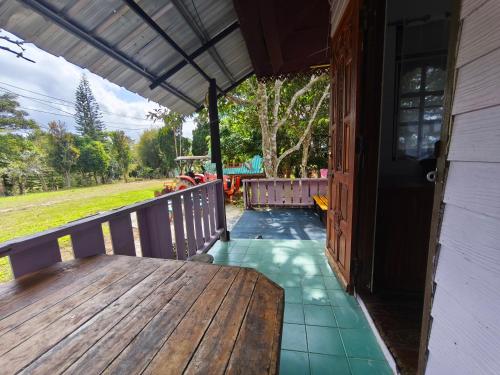 a porch of a house with a wooden table at เขาค้อ ภูดาว Resort & Camping in Khao Kho