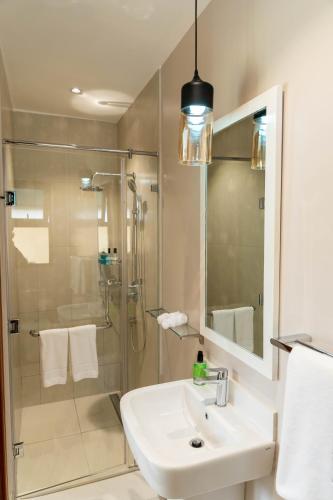 a bathroom with a shower and a sink and a shower at The Meru House in Nkubu
