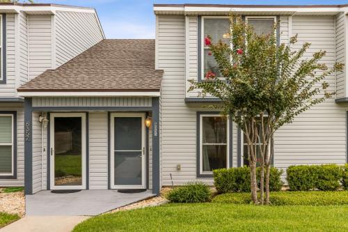 a house with a tree in the front yard at Pet Friendly Beach Retreat - Fernandina Shores - 6355 in Fernandina Beach
