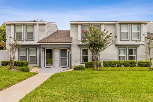 a house with a green lawn in front of it at Pet Friendly Beach Retreat - Fernandina Shores - 6355 in Fernandina Beach