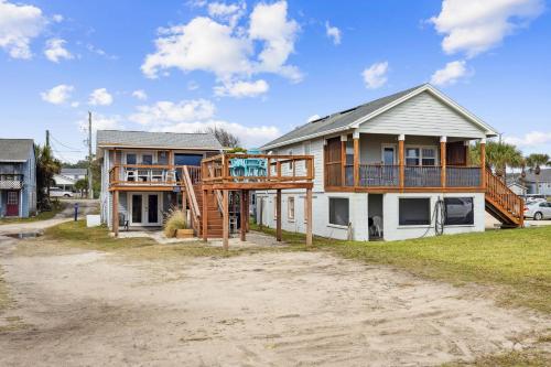 a house with a deck on the side of it at Spacious Beachfront Duplex - Top Floor - Dog Friendly - 124 S Fletcher in Fernandina Beach