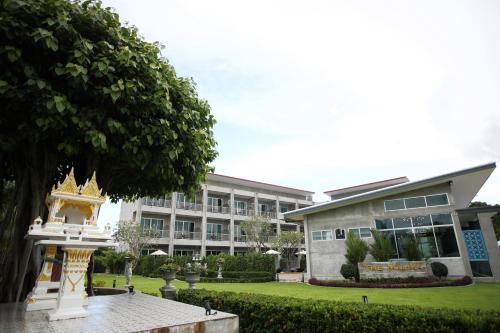 a building with a pagoda in front of it at The Malika Hotel - SHA Extra Plus in Phuket Town