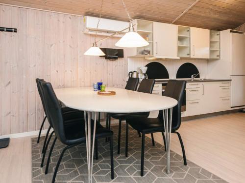 a kitchen and dining room with a table and chairs at 4 star holiday home in Ansager in Ansager
