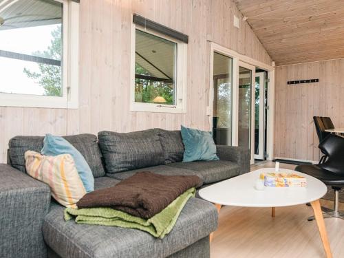 a living room with a couch and a table at 4 star holiday home in Ansager in Ansager