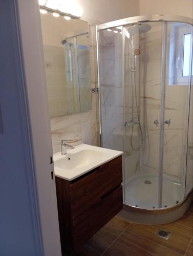 a bathroom with a sink and a shower at Golden Hearth Mountain Chalet in Ano Trikala