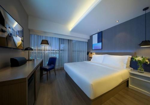 Postel nebo postele na pokoji v ubytování Orange Hotel Chengdu Huanhuaxi