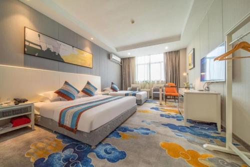 Postel nebo postele na pokoji v ubytování Kunshan Yuxing Hotel