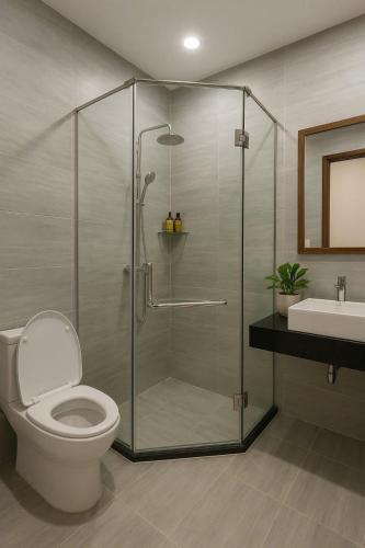 a bathroom with a shower with a toilet and a sink at Solia Villa in Danang