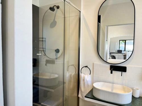 a bathroom with a sink and a mirror at Ibis Cottage Hout Bay with Mountain View Terrace in Hout Bay