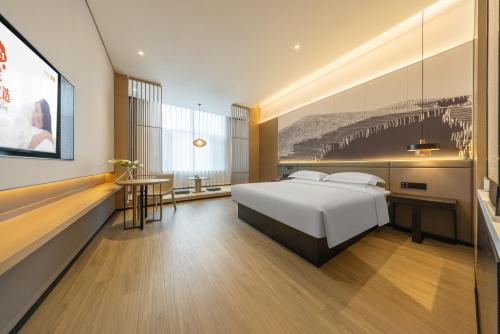 Ένα ή περισσότερα κρεβάτια σε δωμάτιο στο Jin Yi Youxuan Hotel Ulanqab Wanda Branch 2