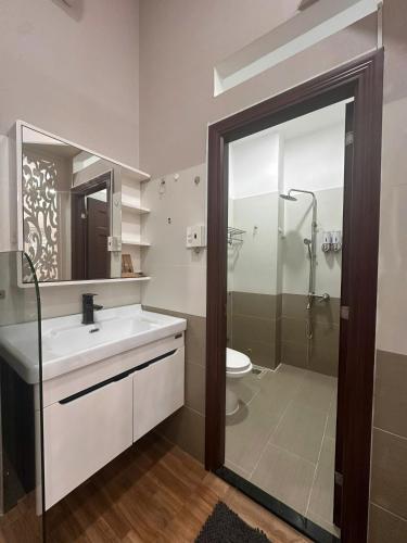 a bathroom with a sink and a shower and a toilet at AP Home in Ho Chi Minh City