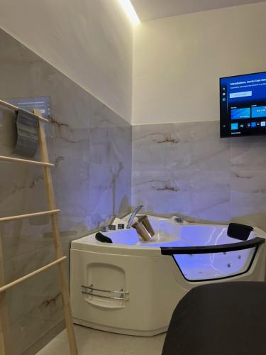 a bathroom with a sink and a tv on a wall at Ad Astra in Brindisi