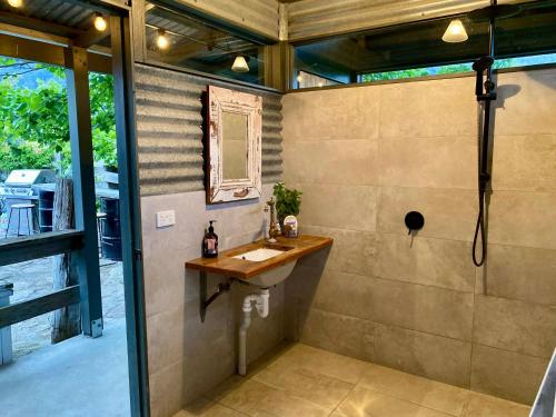 a bathroom with a sink and a mirror at Mountain View Tilba Tilba - Glamping in Tilba Tilba