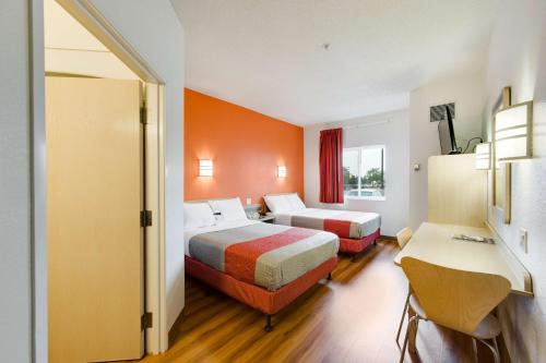 a hotel room with two beds and a desk at Motel 6-Brampton, ON - Toronto in Brampton