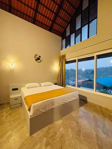 a bedroom with a bed and a large window at Hira Homestay Wayanad, Family-Friendly Stay Near Banasura Dam in Pinangode