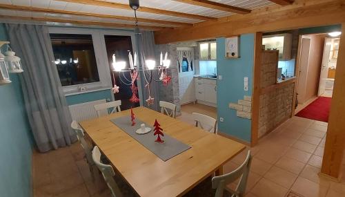 a kitchen and dining room with a wooden table and chairs at Große Strandperle in Fehmarn